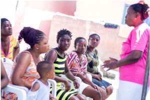 Caroline Lokko (Right), a Public Health Nurse engages participants during the screening exercise