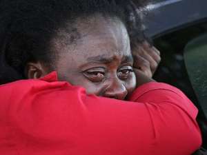 A woman weeps at Ebola treatment center