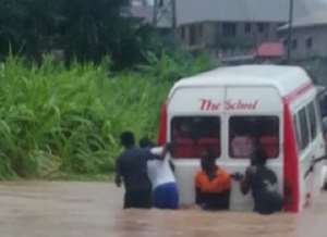 A trapped bus being pushed through the floods