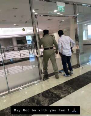 Photo of Nana Appiah Mensah escorted by Emirates Police as he heads to Ghana