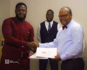 Bishop Gideon Titi-Ofei Right exchanges signed documents with Isaac Jay Hyde, President of NUGS