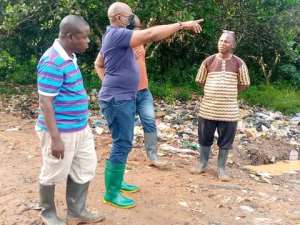 Hon. Evans Addison Coleman (hand stretched) at the dumping site