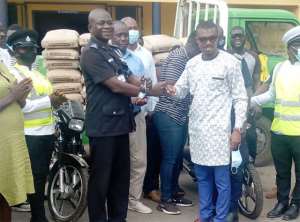 The NaCCA boss and MP elect for Kwesimintsim constituency, Dr Prince Armah (right) making the presentation to the police