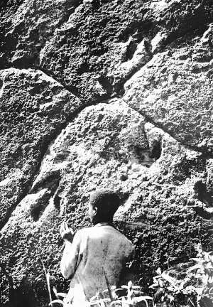 Dinosaur footprints at Morija, Lesotho, in 1906. The person standing in front of the rock slab covered with tridactyl fossil footprints is not identified. - Source: