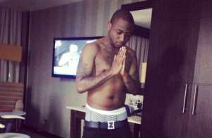 Nigerian singer Davido pictured praying