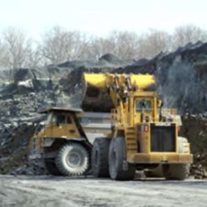 Biting deep into the earth, earth moving equipment at the site of a mining firm