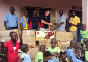 The Operations Manager Of HYSPEC Mining Services- Ghana, Mr. Charlie Harrison Middle Presenting The Items To An Official Of Adullam Orphanage At Obuasi