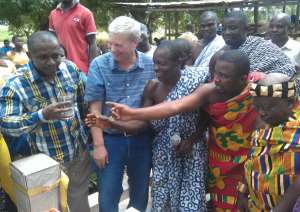 Head of Corporate Communication at Sahara Group, Bethel Ubioma, first from right takes a sip of the fresh water whiles Jim Niquette and Nana Agyei IV, far left with his elders of Adum-Kwanwoma look on