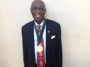 Dr. Thomas Mensah wearing the NAI Gold Medal