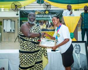A student of Kibi PCoE receiving an award from Mawerehene of Akyem Abuakwa traditional area, Barima Yaw Oppong Krodie