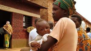 A mother and her child wait at an HIV clinic