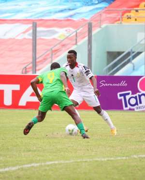 Ghana winger Osman Bukari in white in action against Sao Tome  Principe at the Accra Sports Stadium