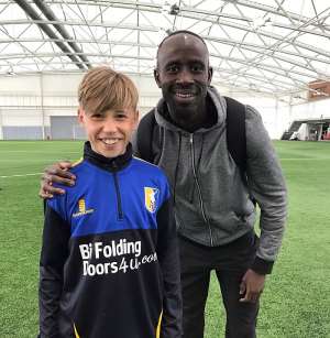 KIND GESTURE: Aston Villa's Albert Adomah trains young players of Mansfield Town