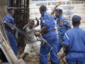 A defenseless African child being beaten by law enforcement agents