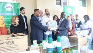 Ahmed Dayekh middle handing over the items to the management of KBTH