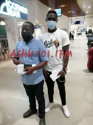 Striker Kwame Poku Right with manager Philip Binney Left at the Kotoko International Airport. Photo CreditAshh FM