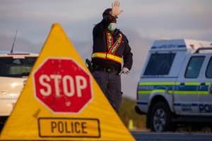 A police officer at a 24-hour roadblock  in Cape Town, South Africa after the country went into lockdown. - Source: Photo by Roger SedrusGallo Images via Getty Images