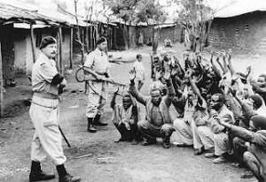 British colonial officers stand guard in Africa. They physically and psychologically tortured innocent Africans in the name of greed.