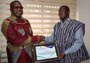 Mr Abdallah Musah right of the Humanity Magazine International presenting the award to Dr. Ben. KD Asante left