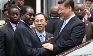 Former Zimbabwe President, Robert Mugabe shakes hands with the Chinese president, Xi Jinping