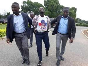 Kojo Mensah M, being taken out of Parliament