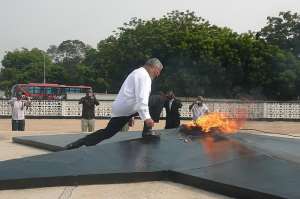 President Rawlings about to touch the perpetual flame lit in honour of the fallen heroes of the revolution