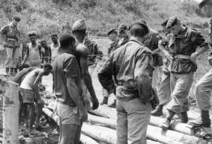 ZaireCongo: Belgium paratroopers and Congolese men building a wooden bridge