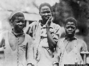 1910: Three Abyssinian slaves in iron collars and chains.
