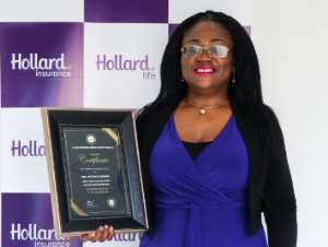 The Group Chief Executive Officer CEO of Hollard Ghana, Patience Akyianu showcasing her award