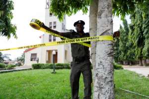 A police officer ties a crime scene tape in Owo, Ondo, Nigeria on June 6, 2022. Authorities charged Wikkitimes publisher Haruna Mohammed Salisu and reporter Idris Kamal with criminal conspiracy and defamation on June 28. ReutersTemilade Adelaja