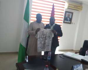 HE Abikoye L with Alhassan displaying the peace shirt