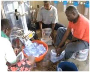 Workers busily package sachet water after production before consumption