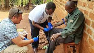 Fort Detrick researchers from America, taking a blood sample of an Ebola survivor in Uganda