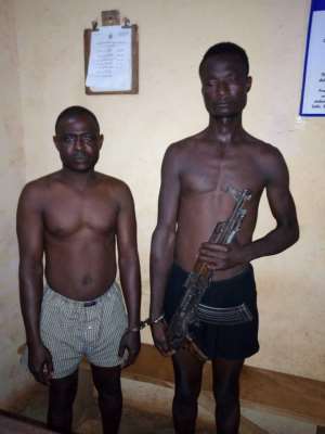 The Suspects Lara Babtua and Kinansua Mabagor with the AK47