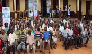 A cross-section of farmers waiting to be screened