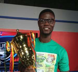 Nii Ayittey Nunoo poses with the trophy at stake