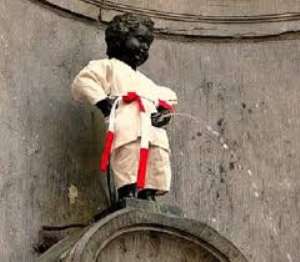 Little boy Manneken in judo outfit urinating in Brussels