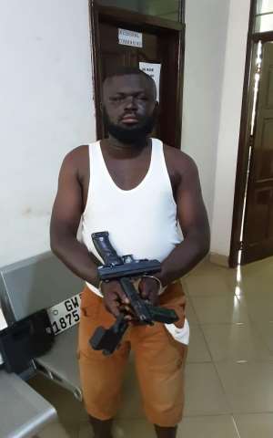 Suspect Alhassan Imrani with the weapons at the Northern Regional Police Command