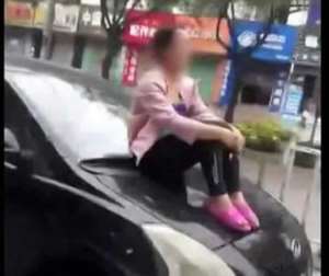 Man fined for driving off with wife on hood of car In China