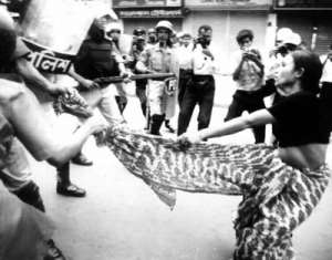 A woman being harassed by male police officers on the street.