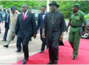 President Mills being led by President Jonathan right on arrival at the Abuja International Airport.