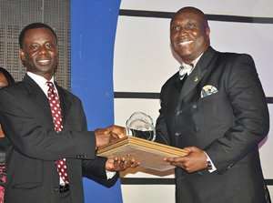 Samuel Sarpong G Chief Transformation Officer of GCB receiving the award from Mr. Clifford Duke Mettle, President of the Chartered The Chartered Institute of Bankers