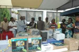 The National Organiser of the OPASS Old Students Association, Mr Charles Arthur (left), presenting the items to Mrs Kate