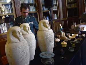 General Director of the Spanish Guardia Civil, Arsenio Fernandez, looks at some of the Egyptian archeological pieces displayed in Madrid's National Archeological Museum on January 28, 2015.  By Pierre-Philippe Marcou AFP