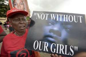 A member of Bring Back Our Girls movement carries placard to press for the release of the missing Chibok schoolgirls in Lagos, on April 14, 2016.  By PIUS UTOMI EKPEI AFPFile
