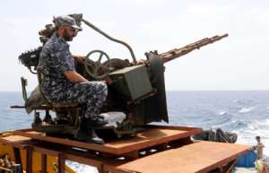 A member of the Libyan coastguard mans a machinegun on a patrol boat off the coast of Misrata on May 9, 2015.  By Mahmud Turkia AFPFile