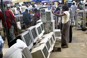 A used-computer vendor attends to a buyer at Lagos' computer village in 2006.  By Pius Utomi Ekpei AFPFile