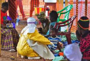 A Doctors Without Borders medical worker feeds an Ebola child victim at a facility in Kailahun, Sierra Leone, on August 15, 2014.  By Carl De Souza AFPFile
