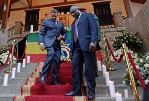 Tanzania's President Jakaya Kikwete L walks down stairs at the Prime Minister's palace in Addis Ababa.  By Carl de Souza AFP