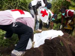 Red Cross volunteers bury bodies on September 15, 2013 in Bossangoa.  By Pacome Pabandji AFPFile